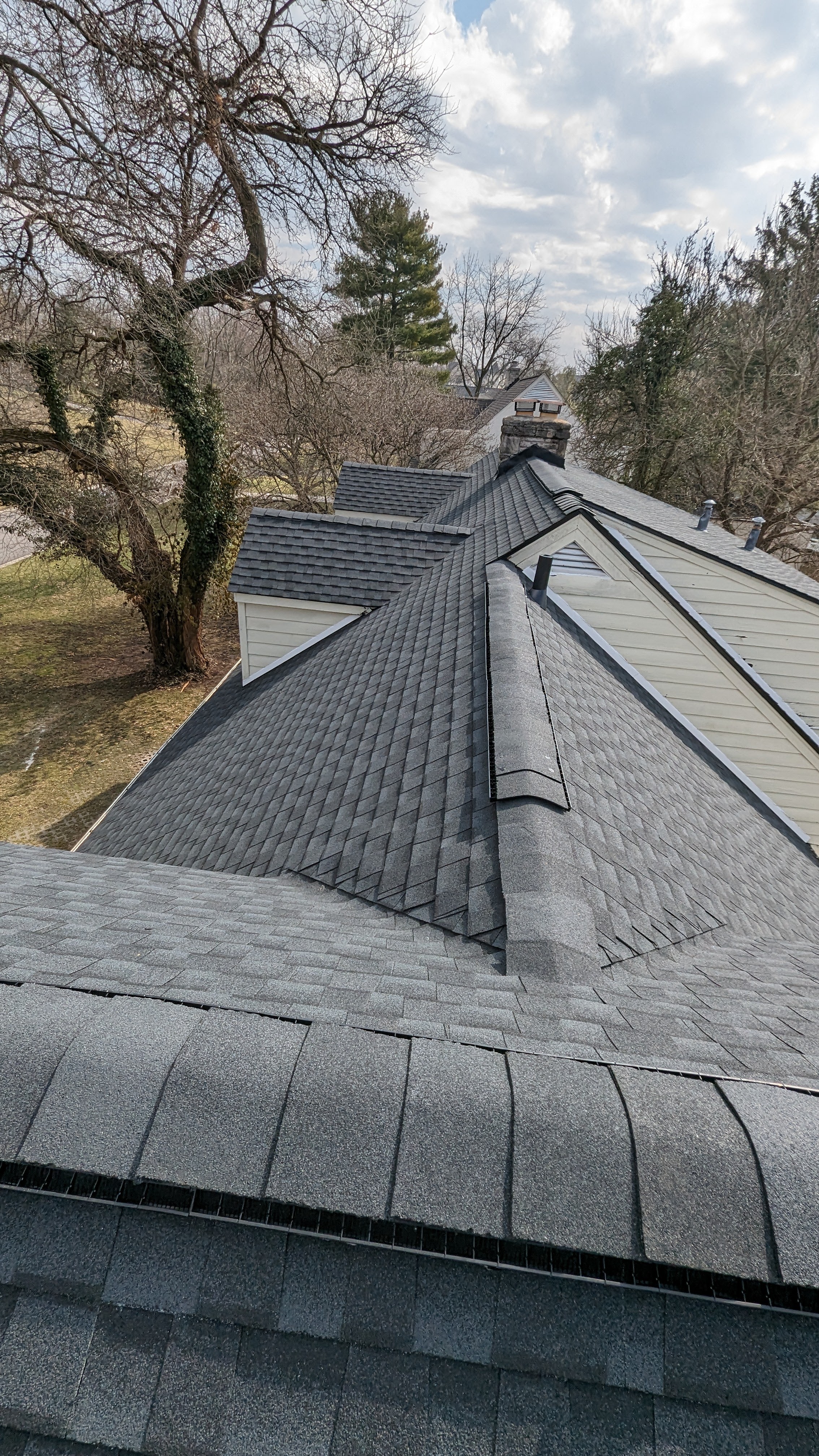 Professional ridge cap and flashing work on residential roof