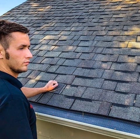 Donovan Davis - DTE Roofing Owner inspecting roof shingles
